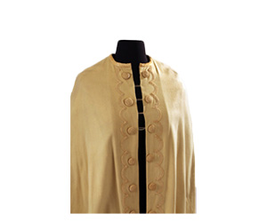 Tan wool cape with large buttons and passementerie detail.