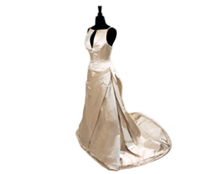 Vera Wang Spring 2004 wedding dress with tool used inside to create fullness at the bottom of gown, bow at the side of the left hip, and high neckline with straps in the back.